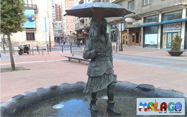 Estatua fuente mujer con paraguas